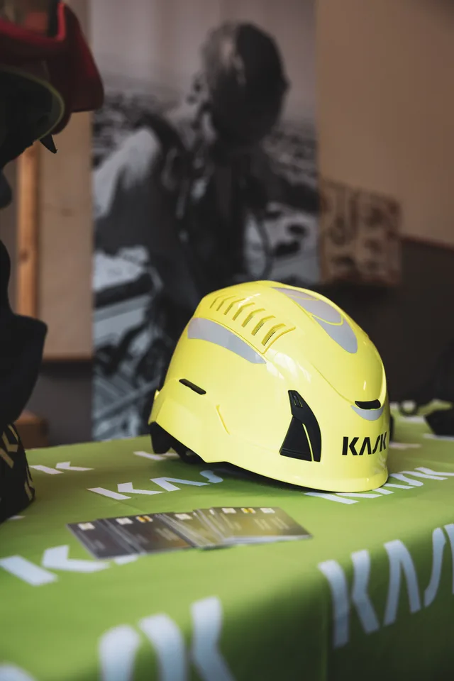 Gelber Feuerwehrhelm auf einem Ausstellungstisch.