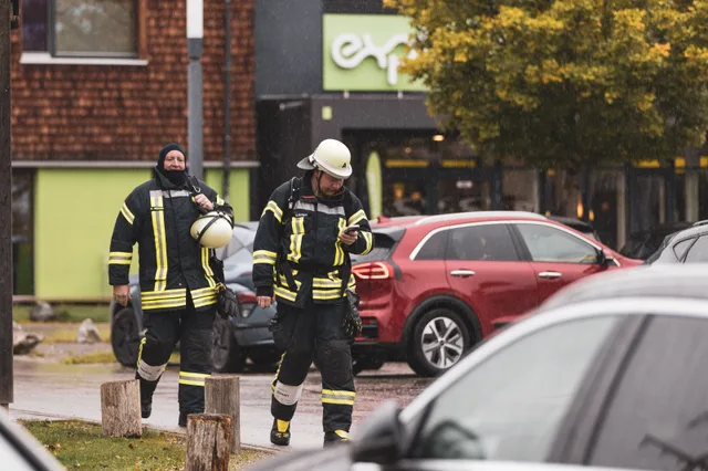 Zwei Teilnehmer in dunkler Einsatzkleidung vor dem Hotel.